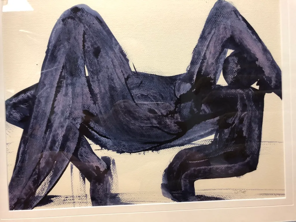 A framed painting in blue-black wash: a seated figure with knees raised, brushed in broad wet strokes.