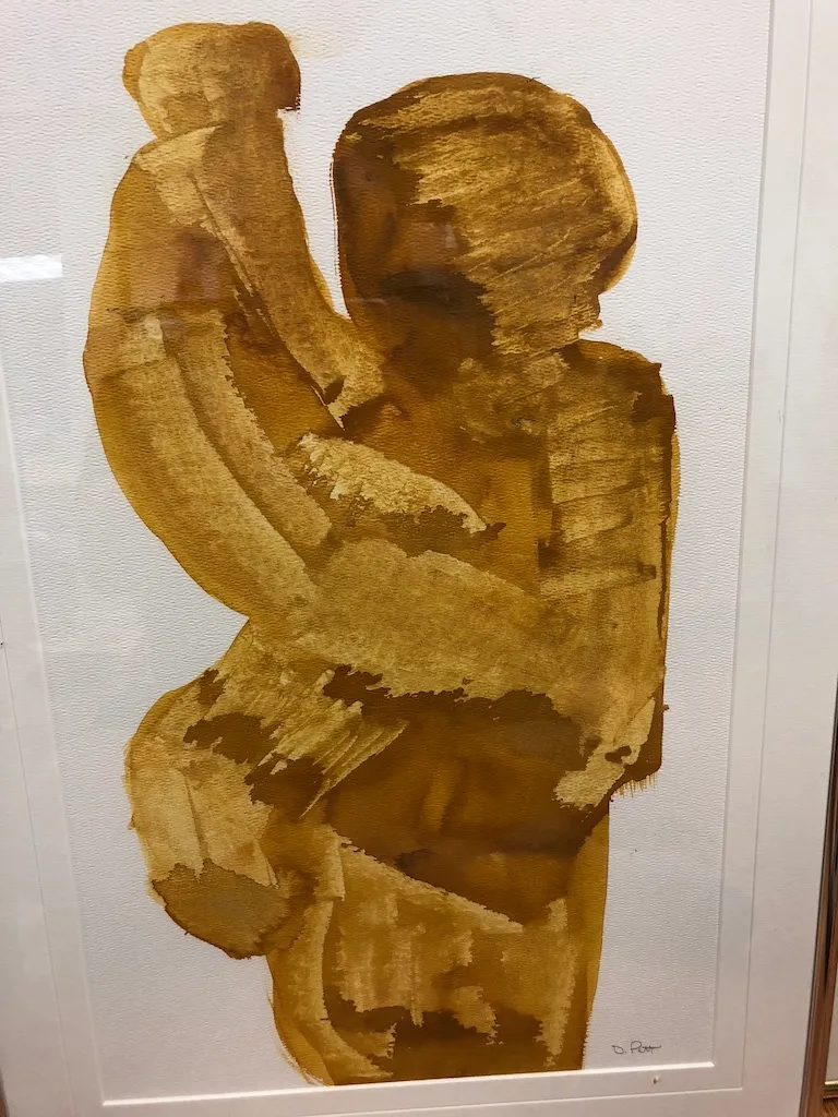 The ochre painting of the embracing pair seen closer, the brush marks open across the bodies.
